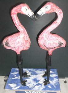 Whimsical flamingos made from paper mache.